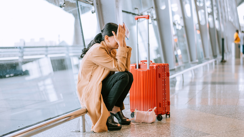Sad, unhappy female traveler