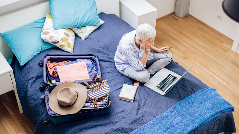 female traveler looking at laptop