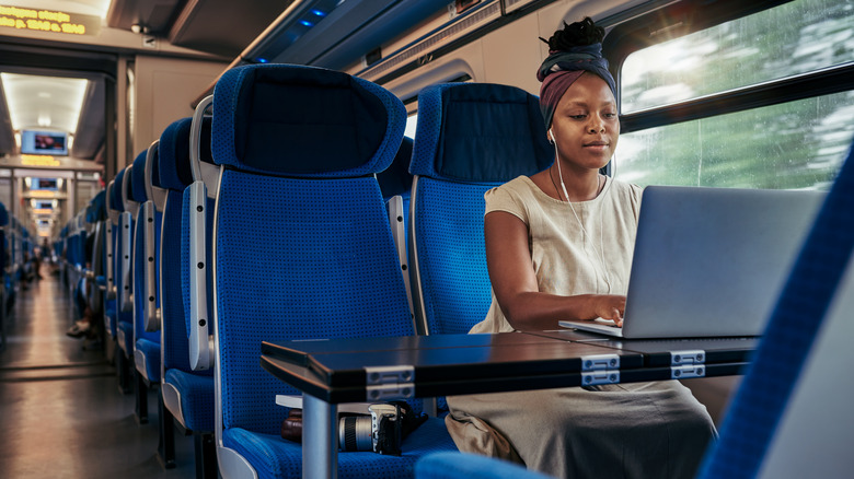 woman with laptop on a train