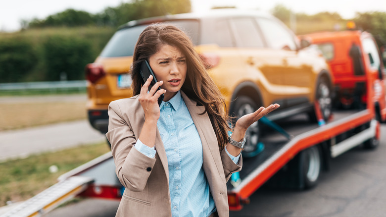 Woman calling roadside assistance