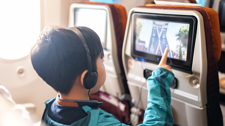 Child uses in-flight entertainment