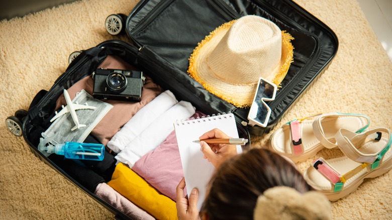 woman packing suitcases