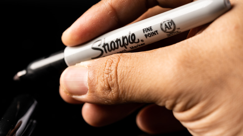 person holding a Sharpie
