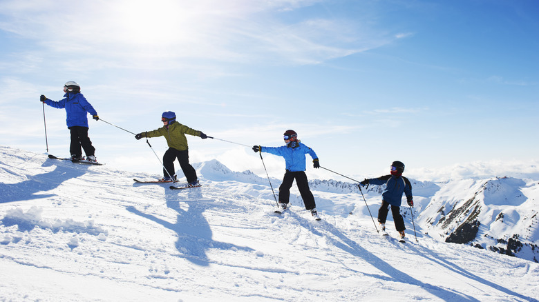 a chain of skiers on a mountain