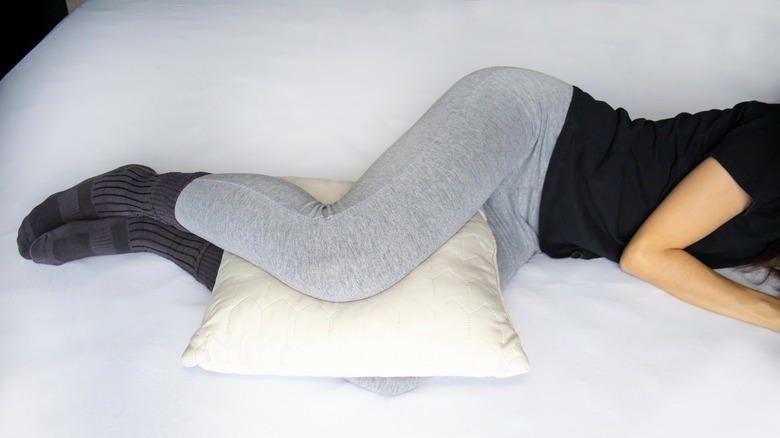 Person sleeping with pillow between the knees