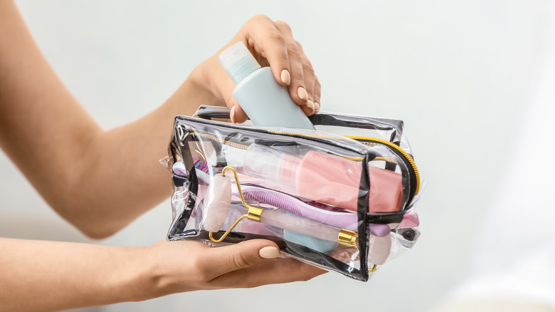 woman packing toiletry bag