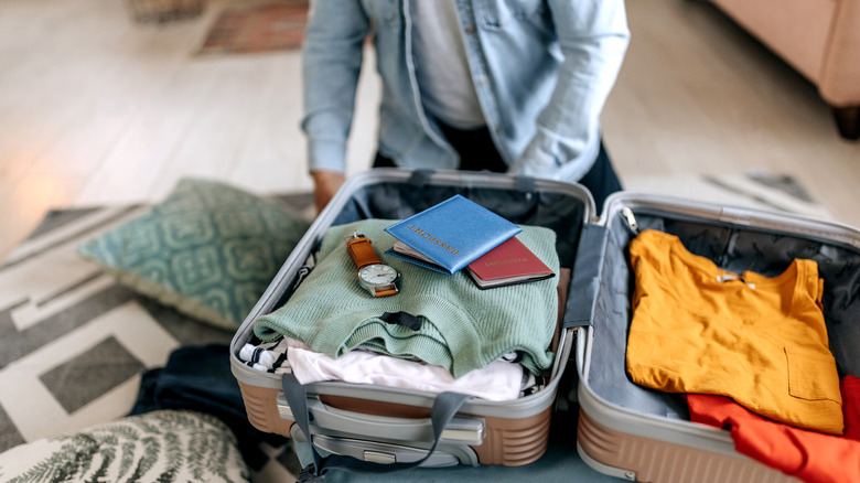 man packing suitcase