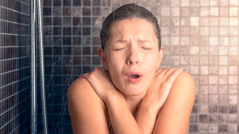 woman reacting to cold shower