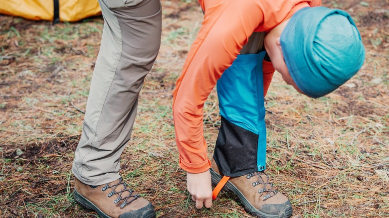 Hiker putting on gaiters 