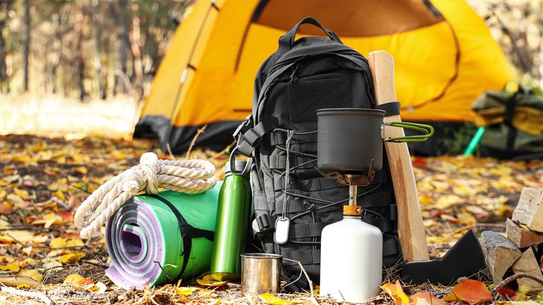 Backpacking tent, rope, stove, water bottle, ax