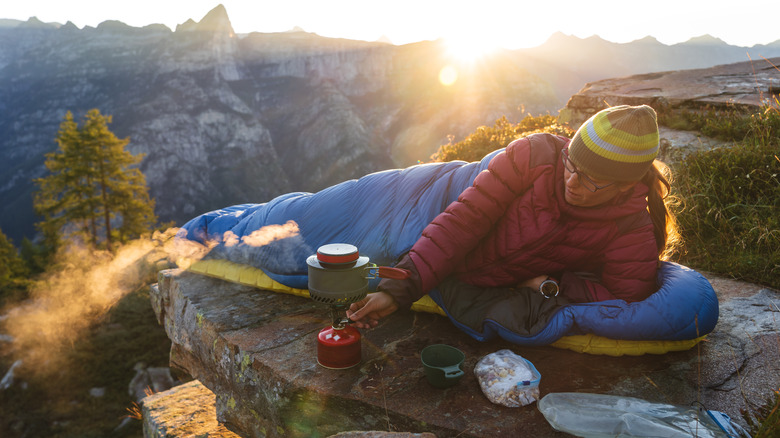 Person cooking breakfast on backpacker stove