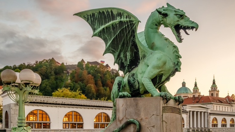 dragon statue in front of buildings