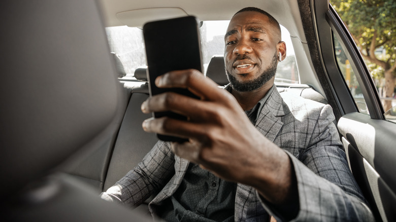 Man with phone in car