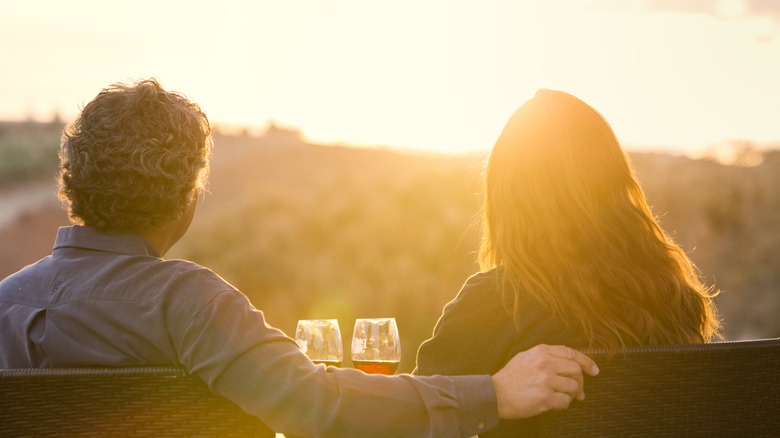 Couple drinking wine at sunset