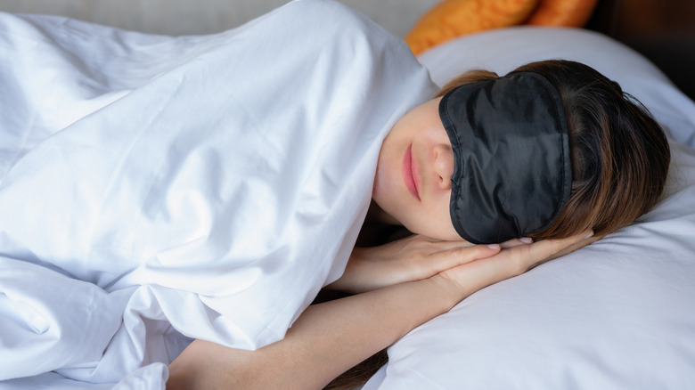 Hotel guest wearing sleep mask