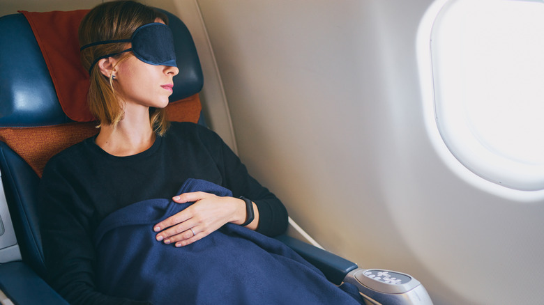 woman sleeping in first-class