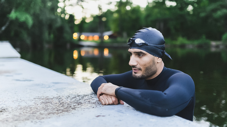 a swimmer resting at the edge of a river