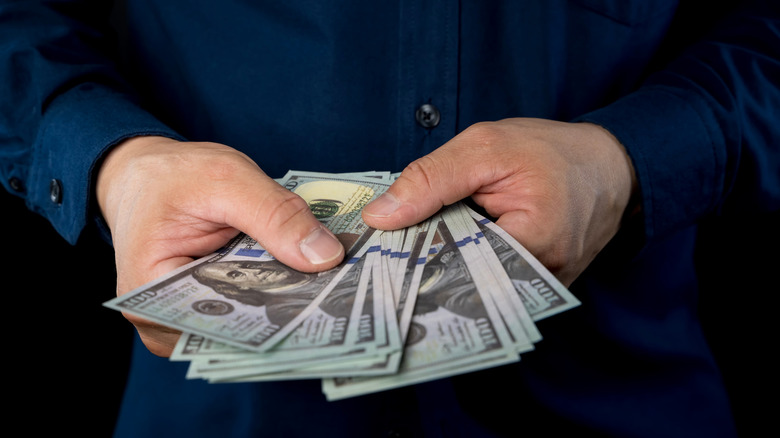 man holding cash in his hands