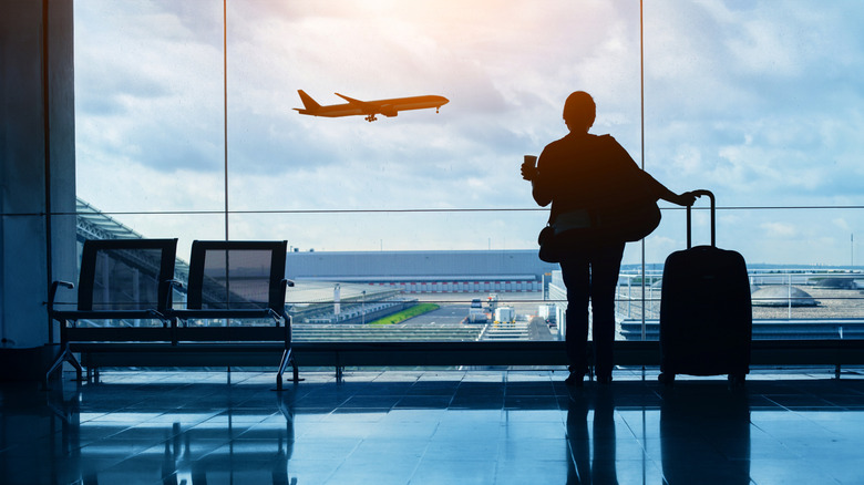 A woman looking out an airplane taking off