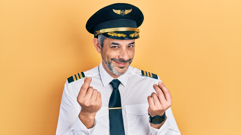 An airline pilot making a funny face