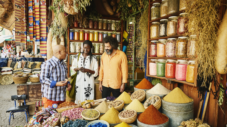 Travelers talking to a local shop owner