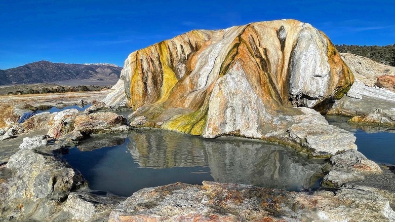 natural pool under colorful rock