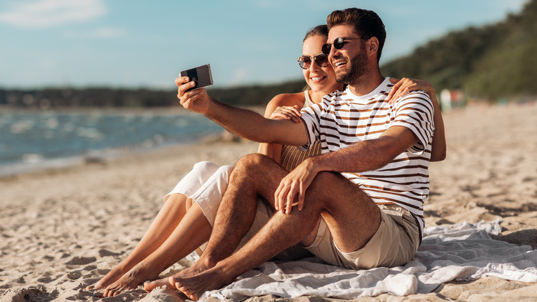 Couple taking selfie on beach