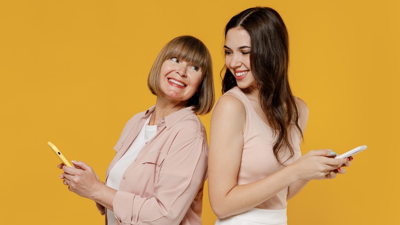 Mom and daughter using phone