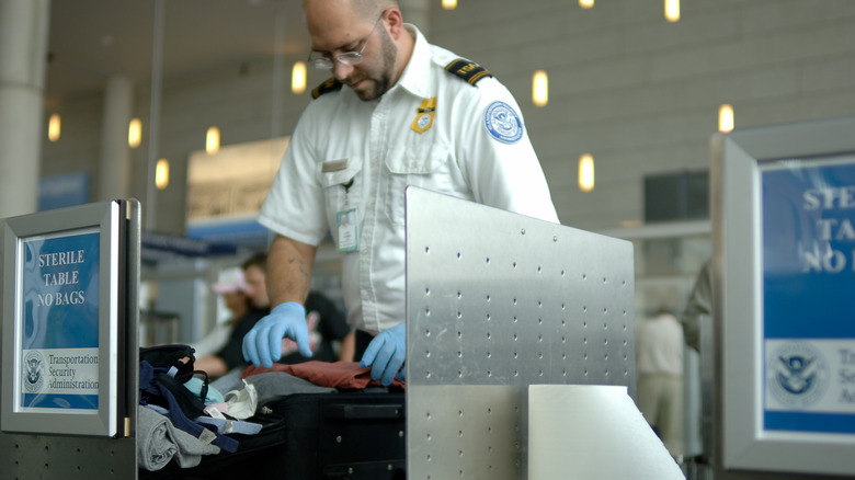 TSA agent searching bag