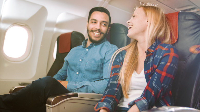 couple smiling on plane