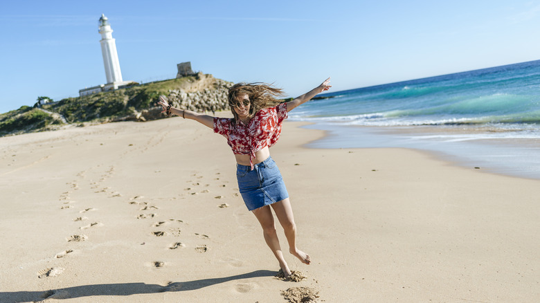 Woman poses on beach in Los Caños de Meca