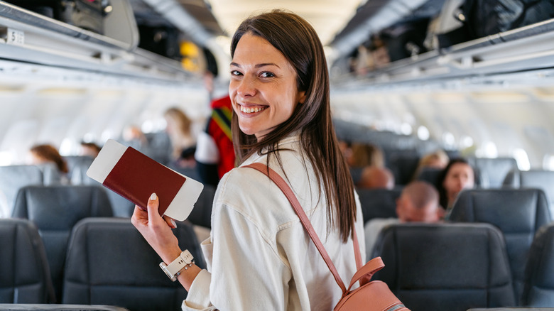 Smiling woman on plane in shirt