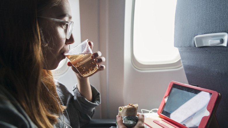 Woman drinking o plane