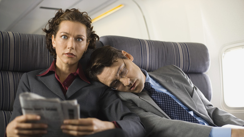 Man sleeping on woman's shoulder