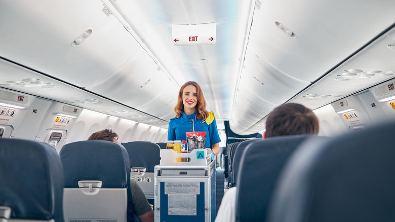 Flight attendant delivering drinks