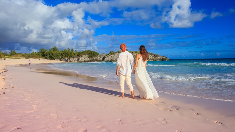 a couple walking on pink sands of Horseshoe Bay