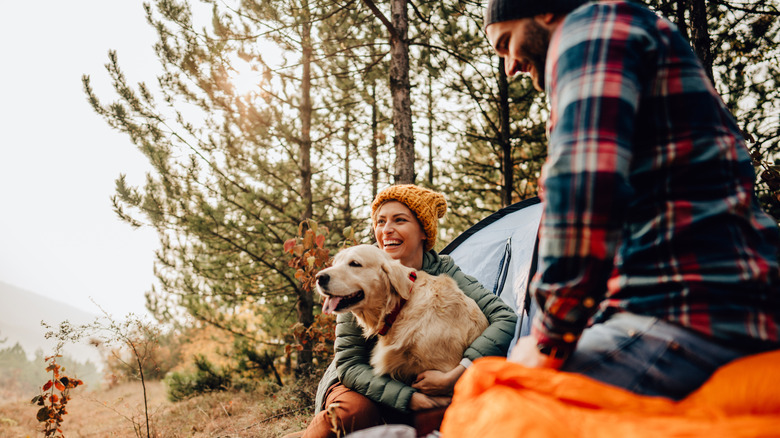 Couple camping with dog