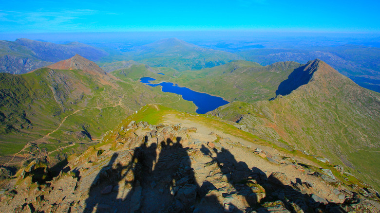 Hiker shadows overlooking Llyn Llydaw Wales