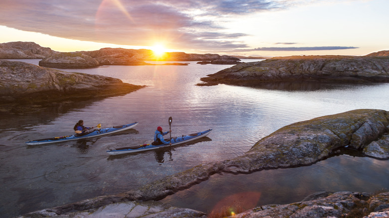 two kayakers in the Stockholm Archipelago at sunset