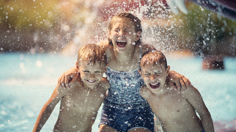 Children laughing in water park