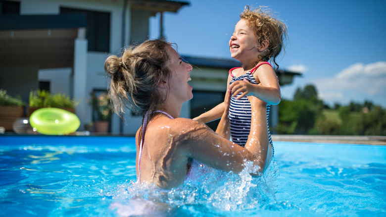 Family playing in swimming pool