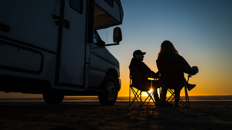 Couple sitting outside RV