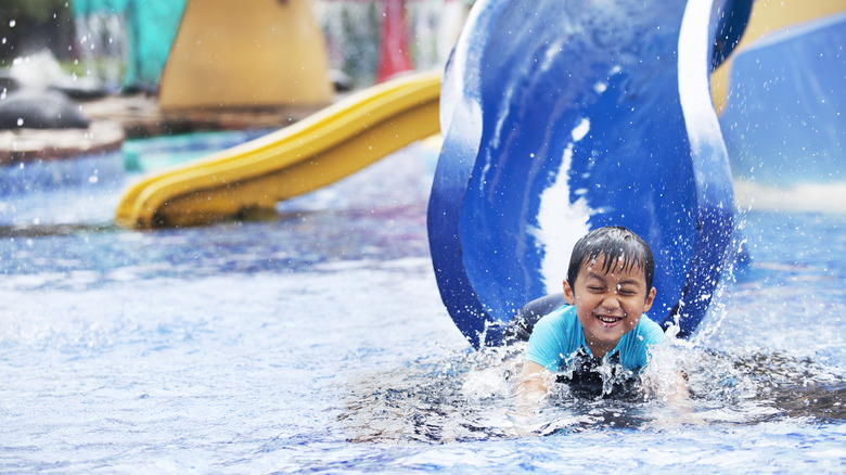 Boy on a water park slide