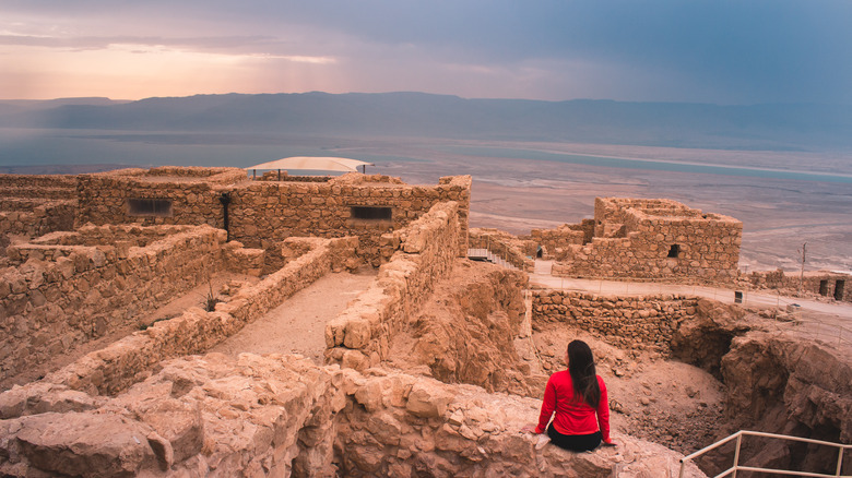 Woman watching sunrise at Masada