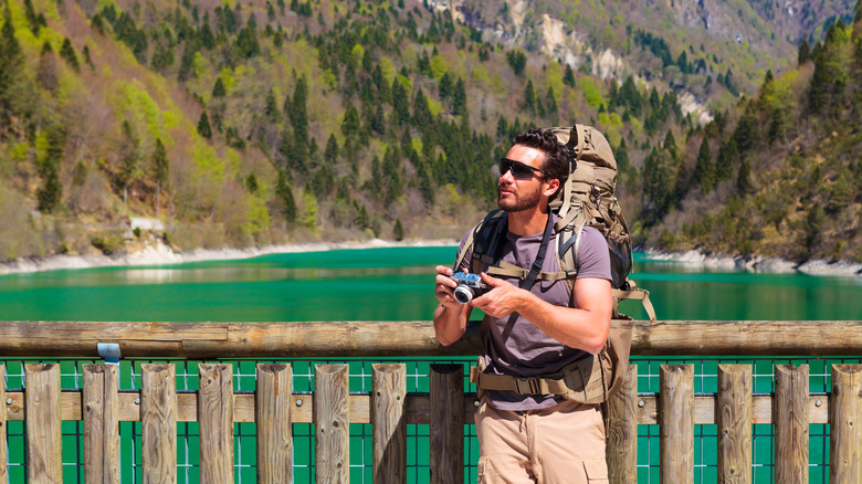 Hiker holding a camera in Dolomiti Bellunesi 