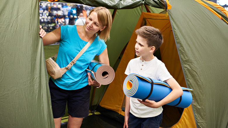 A woman and boy shopping for camping tent