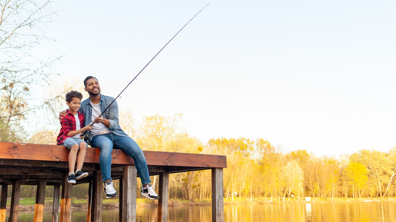 Father and son fishing from pier