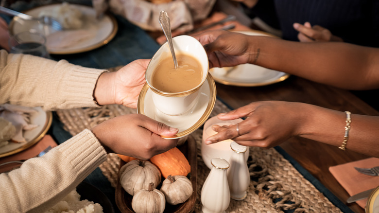 Family passing around gravy boat