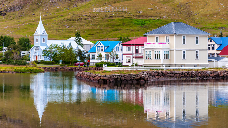 Colorful houses in Seyðisfjörður water reflection