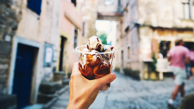 hand holding croatian dessert in a cup
